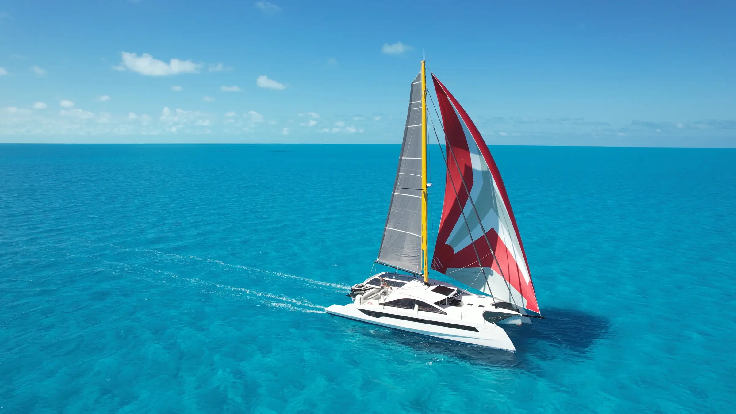 One Cat sailing across a Polynesian lagoon